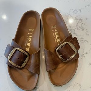 Birkenstock sandals with large gold buckles